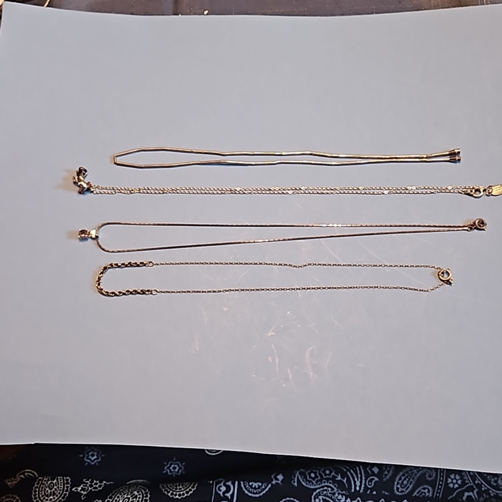 Four silver necklaces